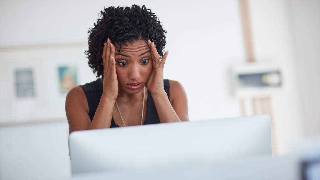 Woman panics at computer due to cyber attack